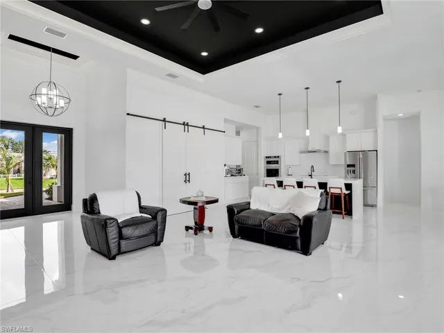 a living room with furniture and a chandelier