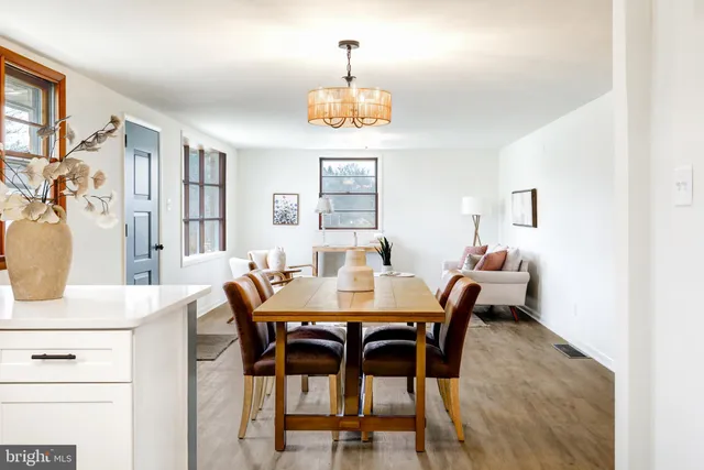 a kitchen with a sink cabinets and wooden floor