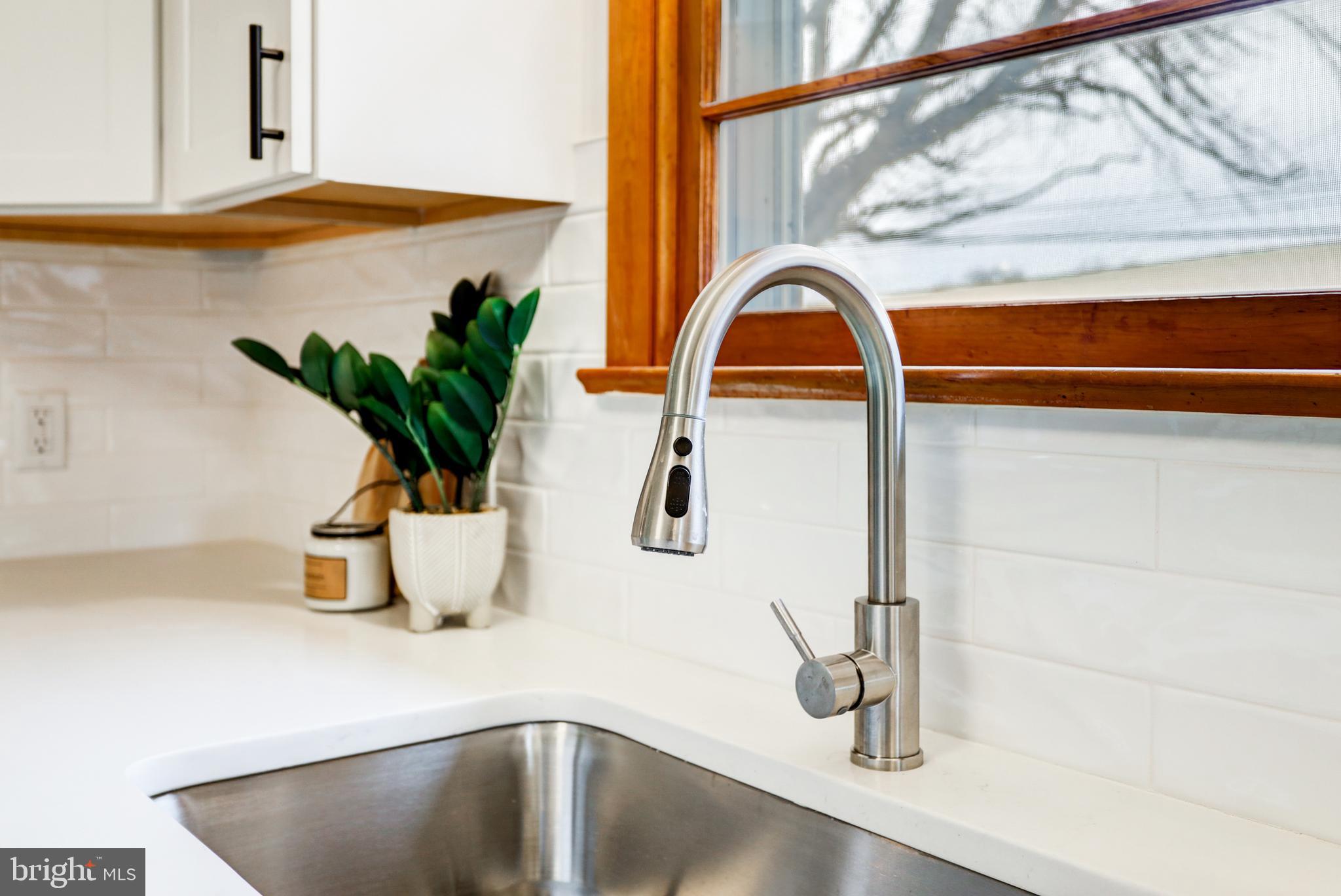 6428 York Road Spring Grove, PA 17362 - Photo 14 of 47 a kitchen sink with a potted plant on the granite counter tops and a glass of window