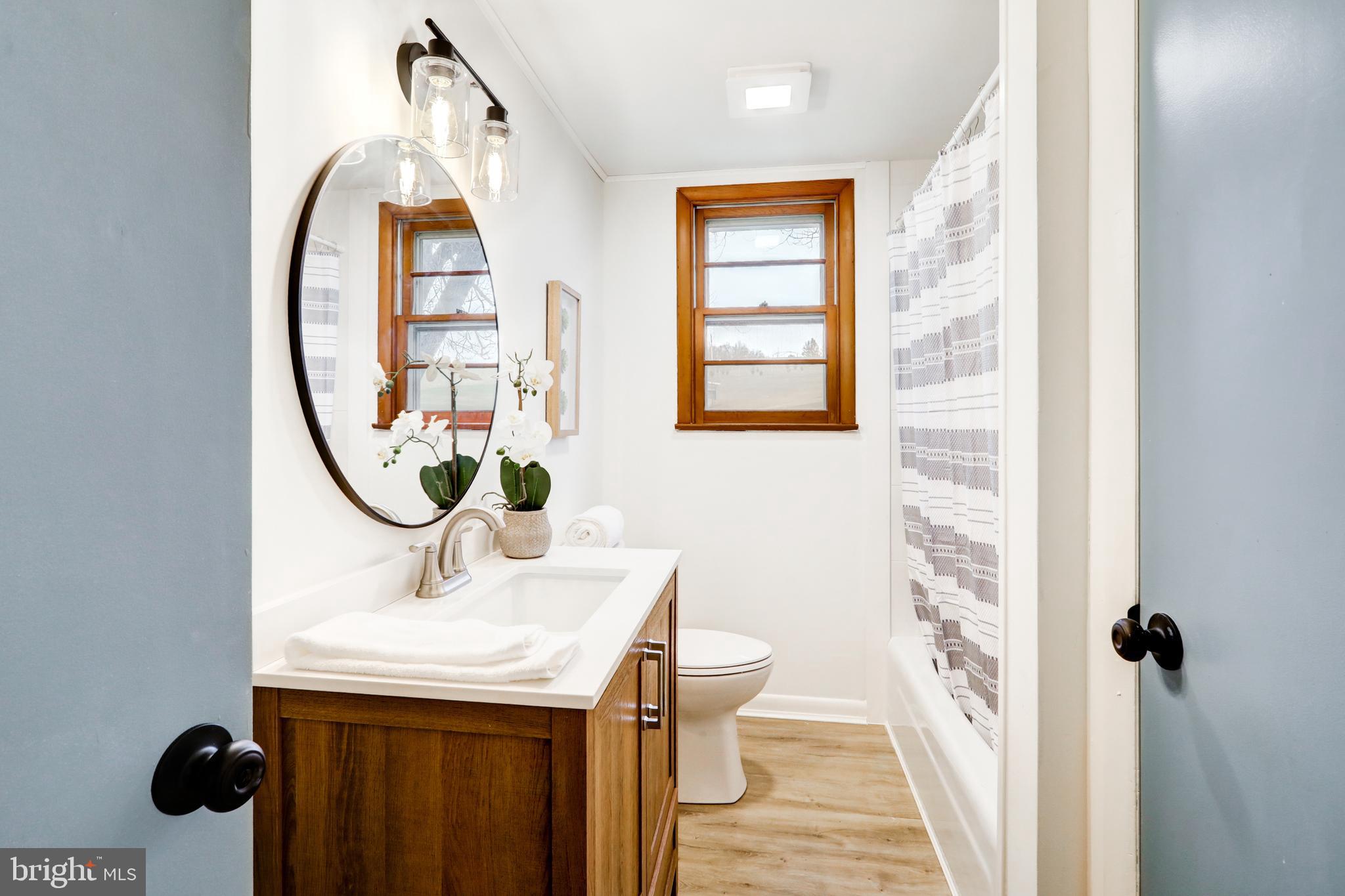 6428 York Road Spring Grove, PA 17362 - Photo 18 of 47 a bathroom with a sink a mirror and a window