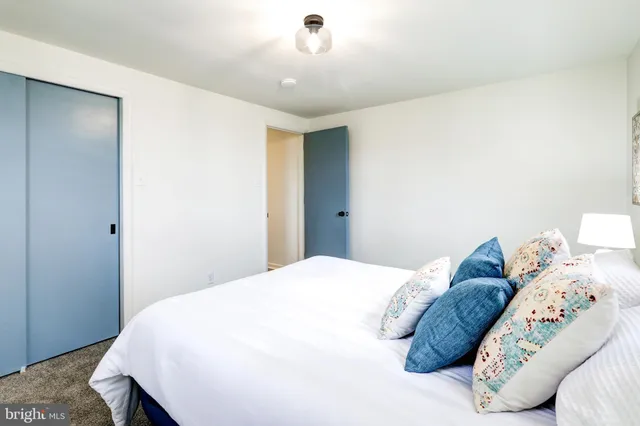 an empty room with windows and closet