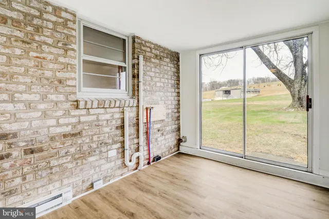a view of an empty room and a window