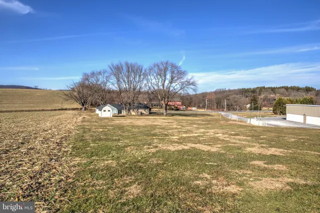 a view of white house with a yard