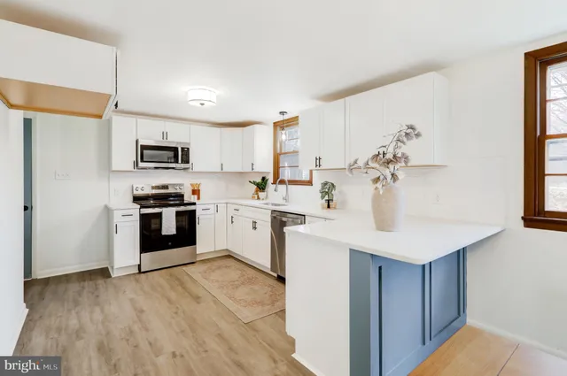 a kitchen with a sink stove and microwave