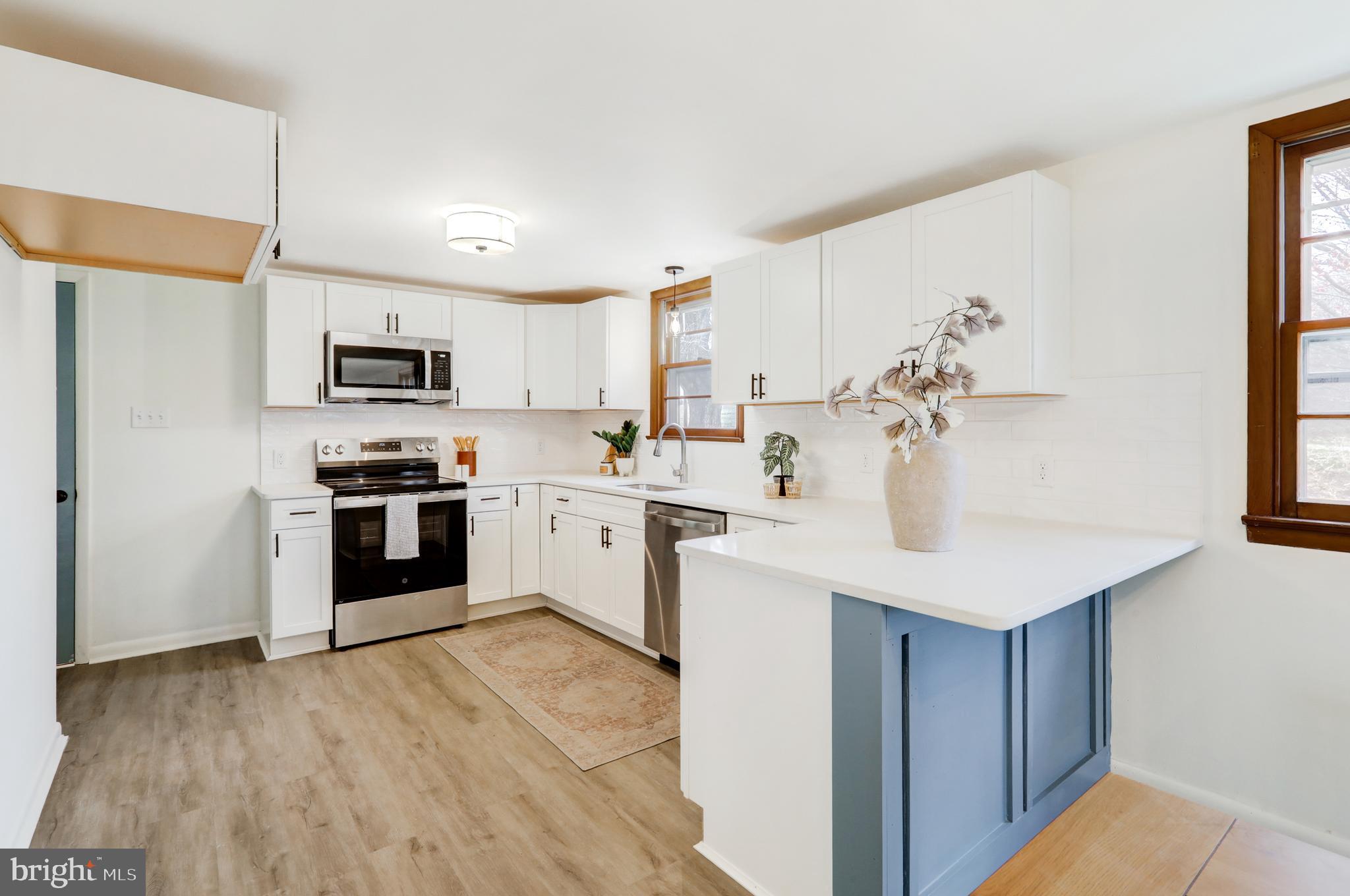 6428 York Road Spring Grove, PA 17362 - Photo 9 of 47 a kitchen with a sink white cabinets and stainless steel appliances