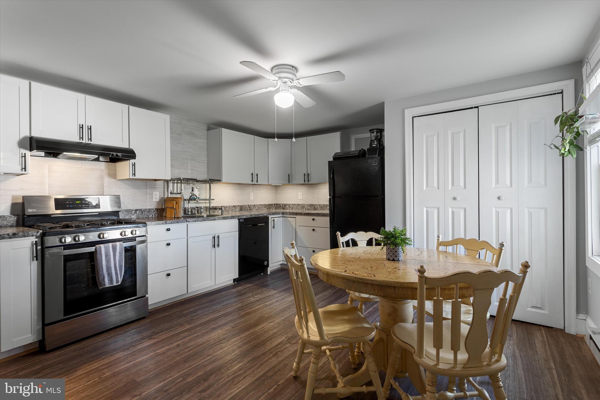 337 Old Charles Town Road Stephenson, VA 22656 - Photo 12 of 27 a kitchen with a table chairs stove and cabinets