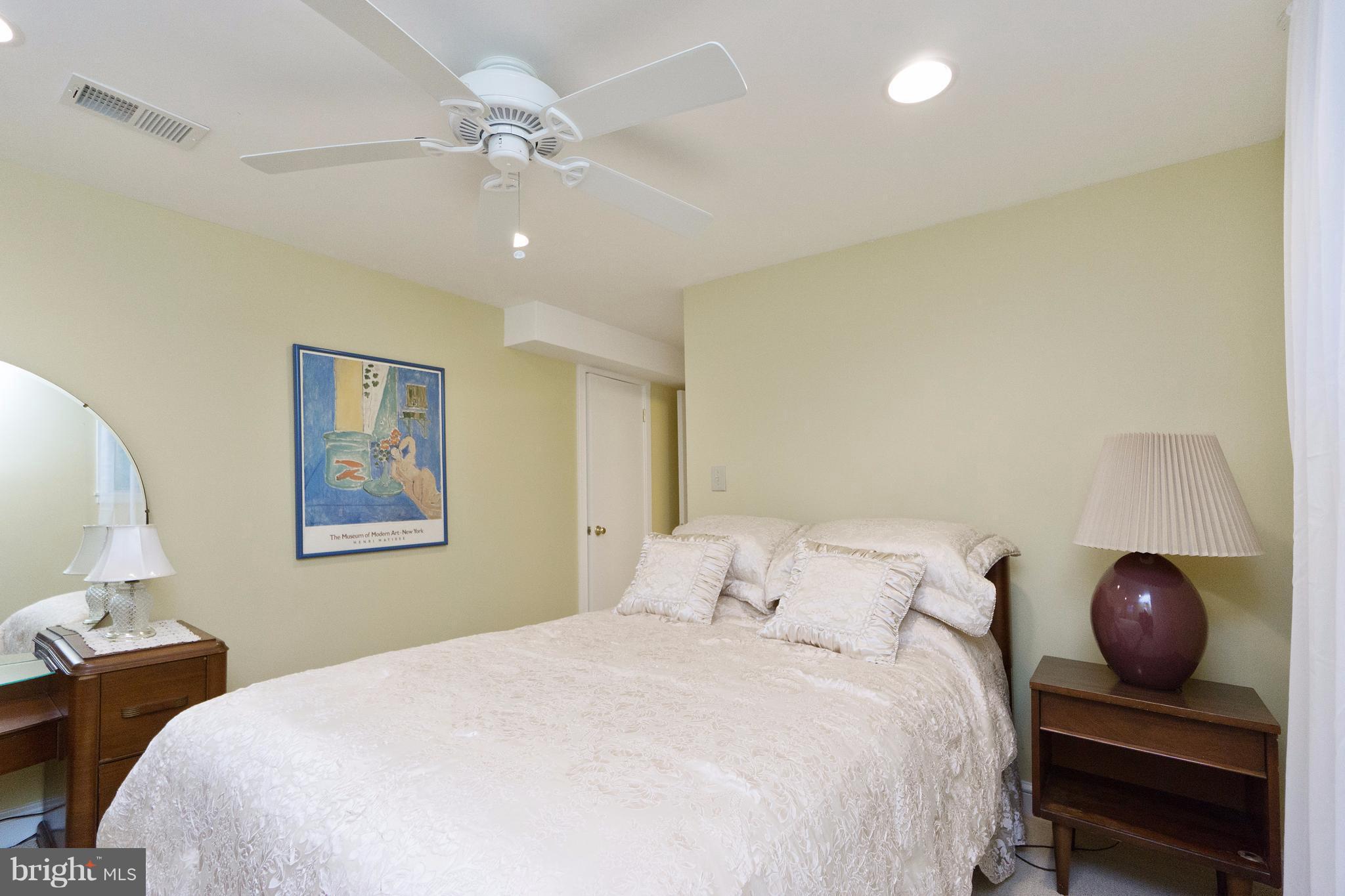 230 Randolph Road Silver Spring, MD 20904 - Photo 16 of 24 a bedroom with a large bed and a chandelier