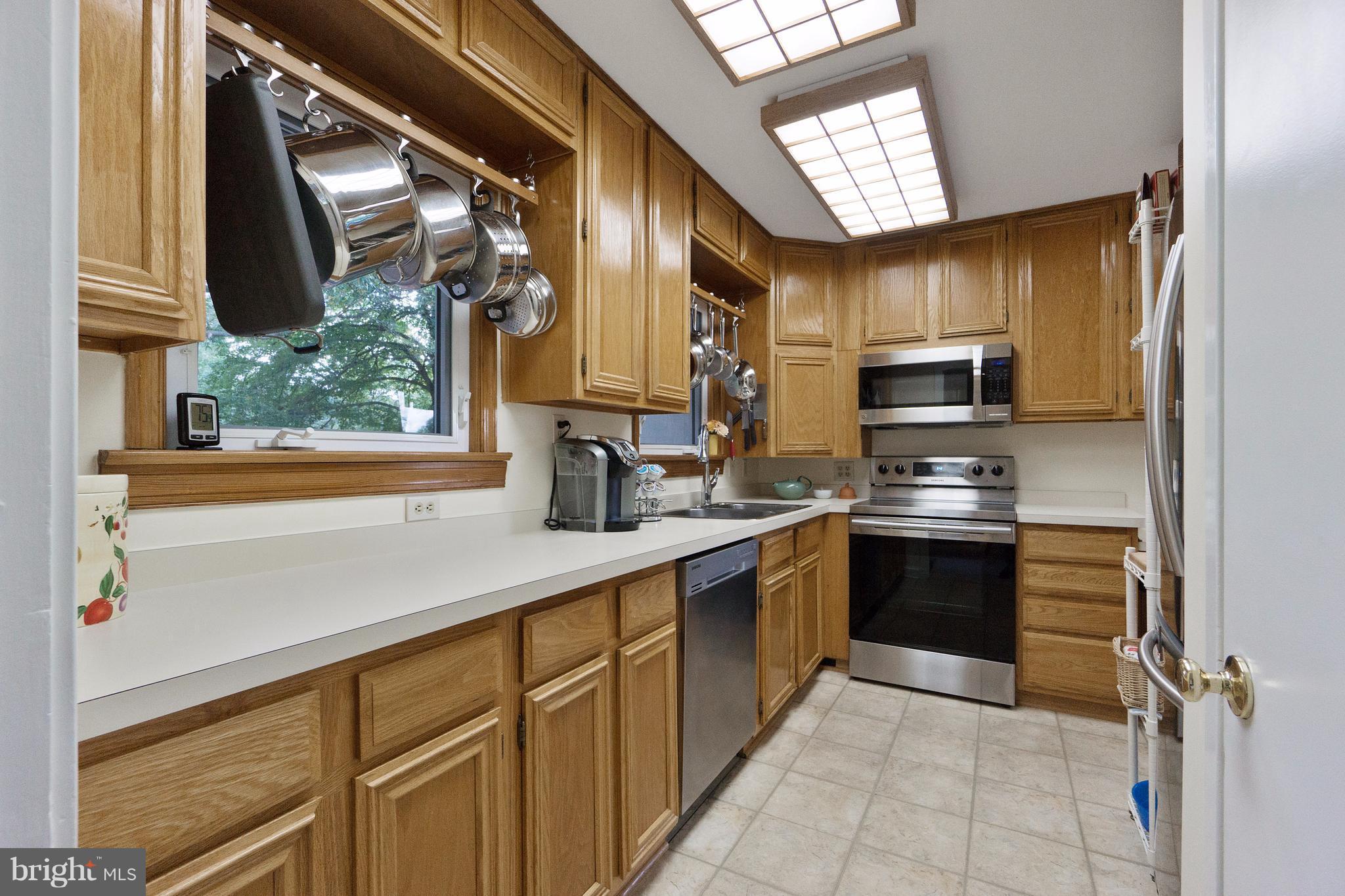 230 Randolph Road Silver Spring, MD 20904 - Photo 8 of 24 a kitchen with stainless steel appliances a sink cabinets and a window