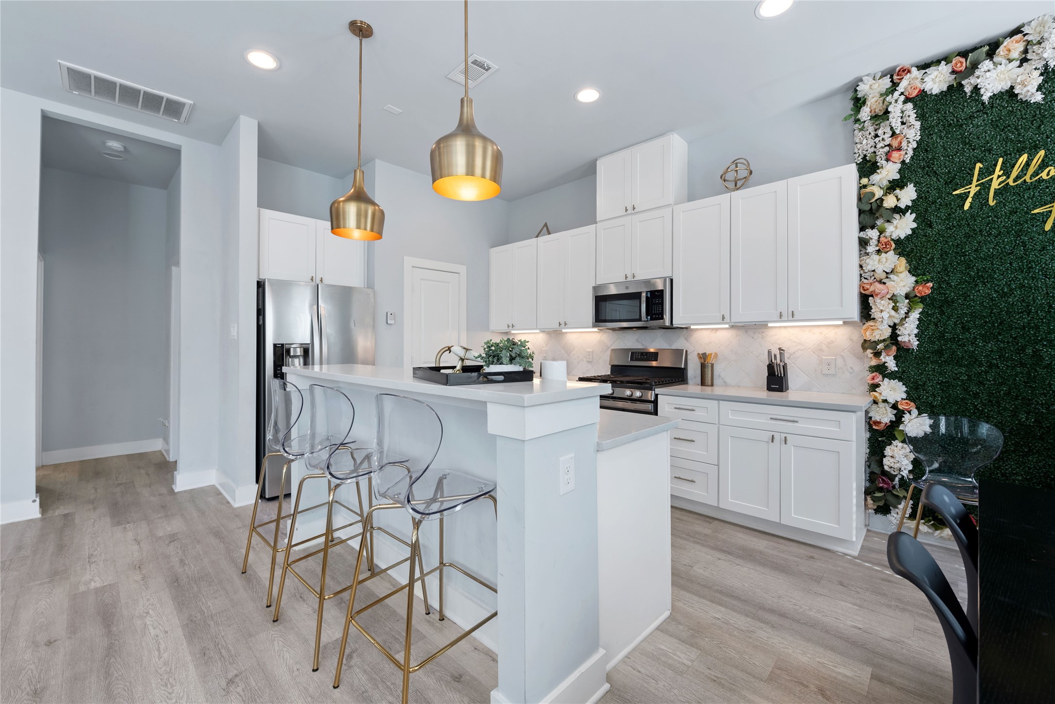 3365 Daphne Street Houston, TX 77021 - Photo 8 of 26 a kitchen with stainless steel appliances kitchen island granite countertop a refrigerator oven a sink dishwasher and white cabinets with wooden floor