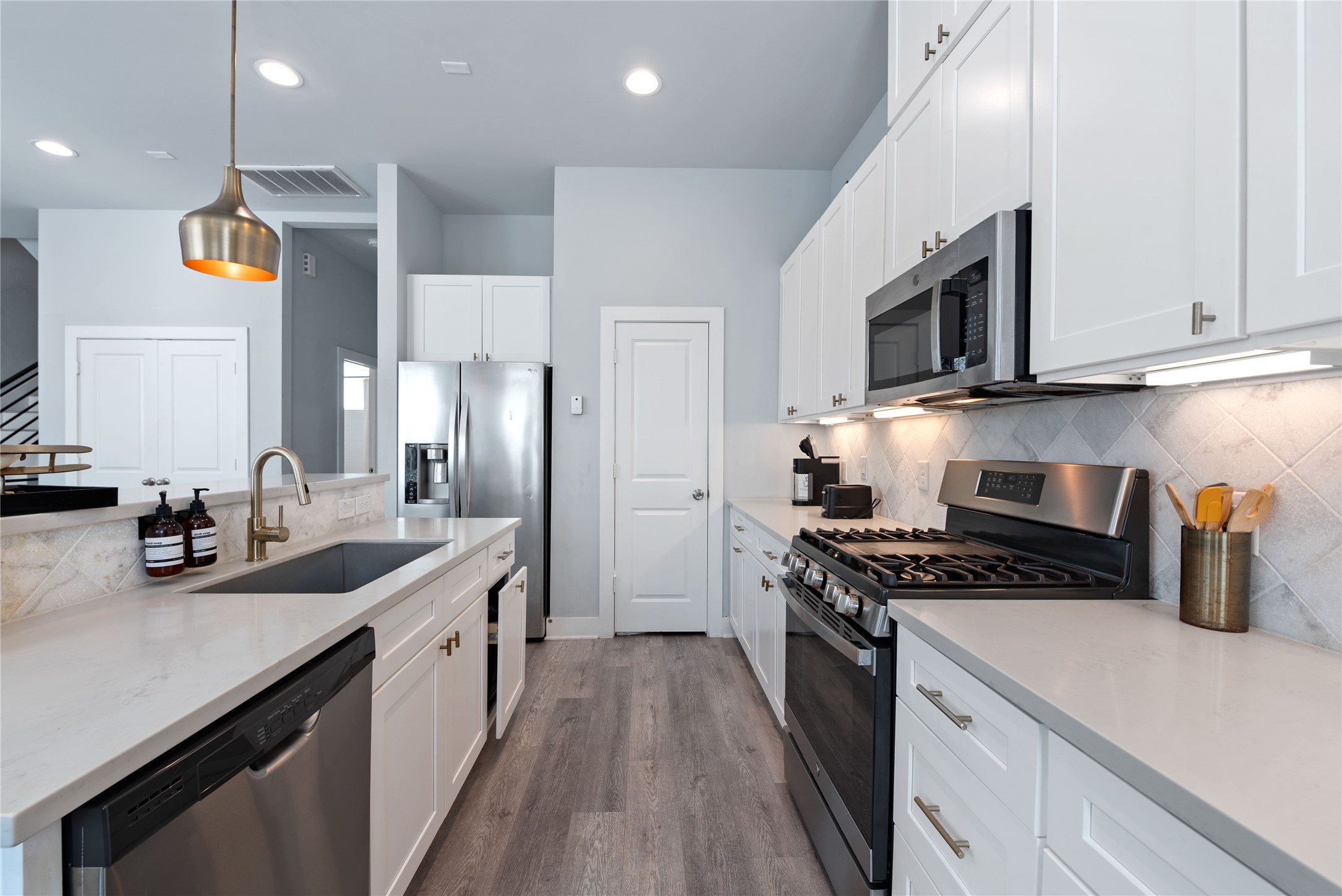 3365 Daphne Street Houston, TX 77021 - Photo 9 of 26 a kitchen with stainless steel appliances a sink a stove top oven a counter space and cabinets