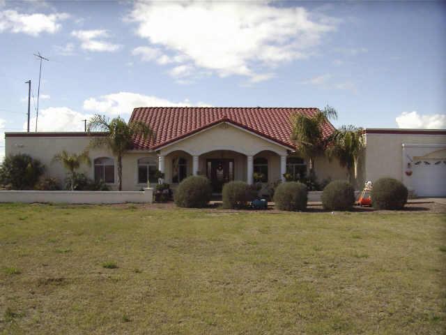 12438 South Gopher Road Buckeye, AZ 85326 - Photo 1 of 4 a front view of a house with a garden