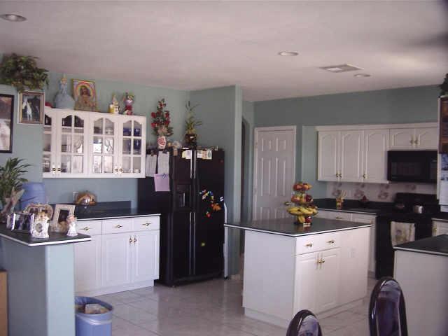 12438 South Gopher Road Buckeye, AZ 85326 - Photo 2 of 4 a kitchen that has a sink and cabinets