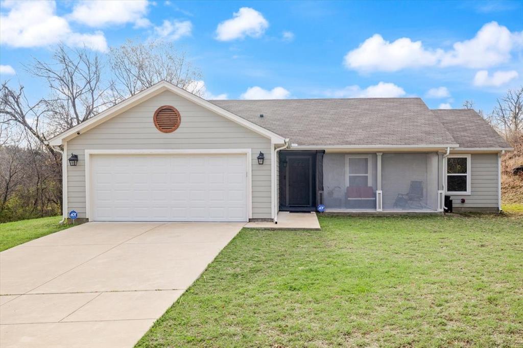 512 Alameda Road Azle, TX 76020 - Photo 1 of 28 a front view of a house with a garden and yard