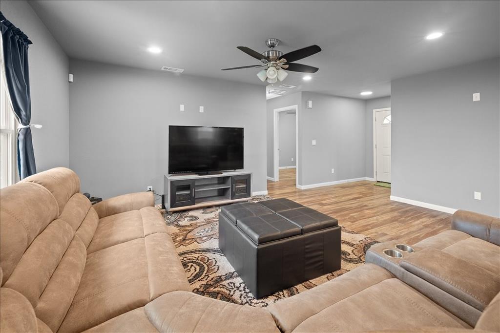 512 Alameda Road Azle, TX 76020 - Photo 11 of 28 a living room with furniture and a flat screen tv