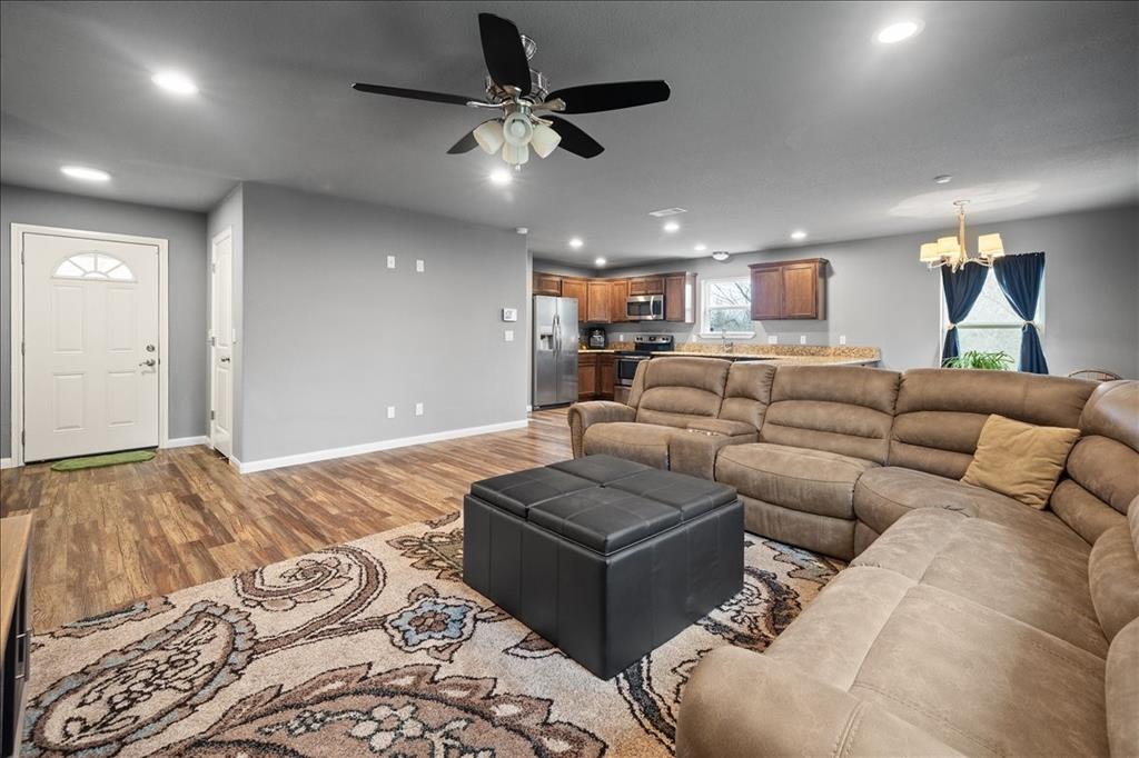512 Alameda Road Azle, TX 76020 - Photo 13 of 28 a living room with furniture a ceiling fan and a rug