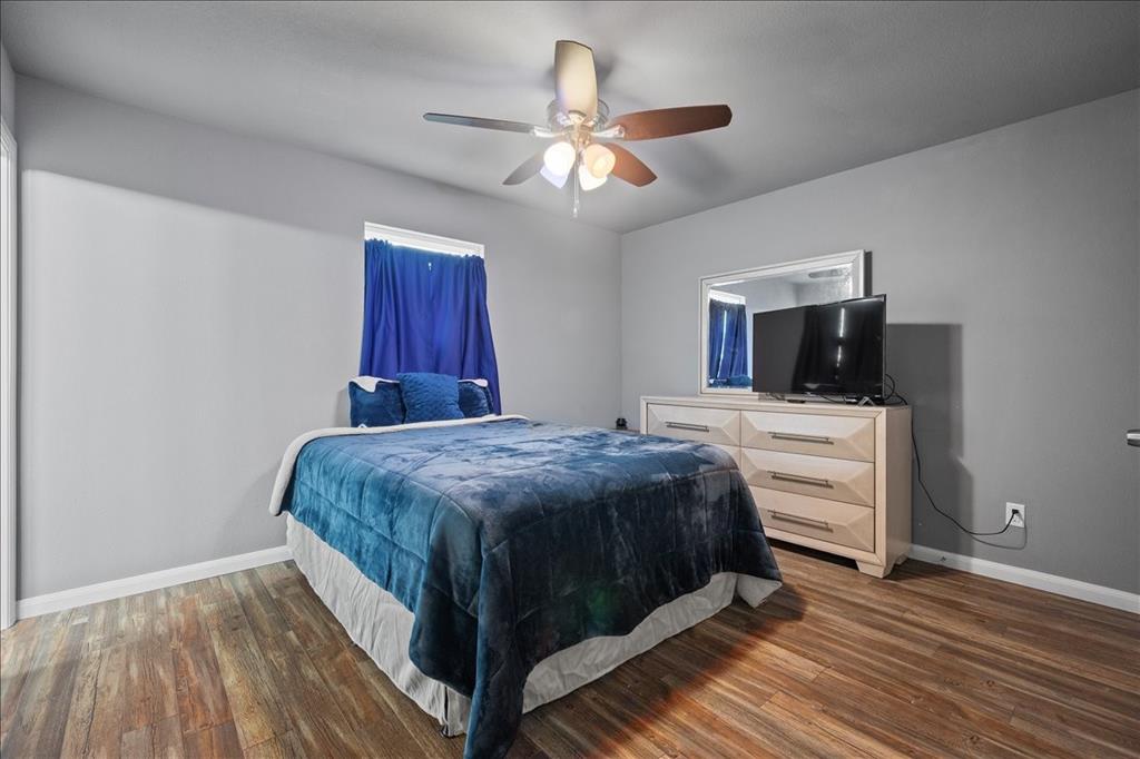 512 Alameda Road Azle, TX 76020 - Photo 14 of 28 a bedroom with a bed and a flat screen tv