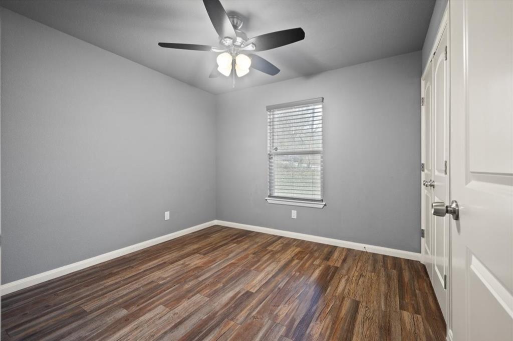 512 Alameda Road Azle, TX 76020 - Photo 17 of 28 wooden floor in an empty room with a window