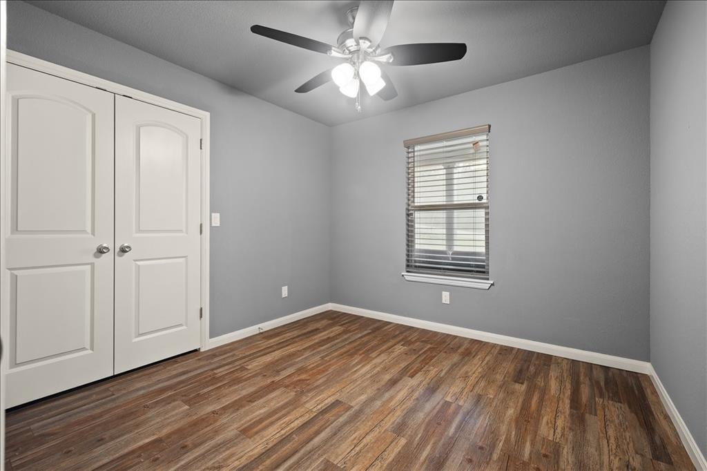 512 Alameda Road Azle, TX 76020 - Photo 20 of 28 a view of an empty room with wooden floor and a window