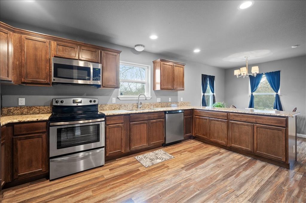 512 Alameda Road Azle, TX 76020 - Photo 9 of 28 a kitchen with a sink stove and microwave