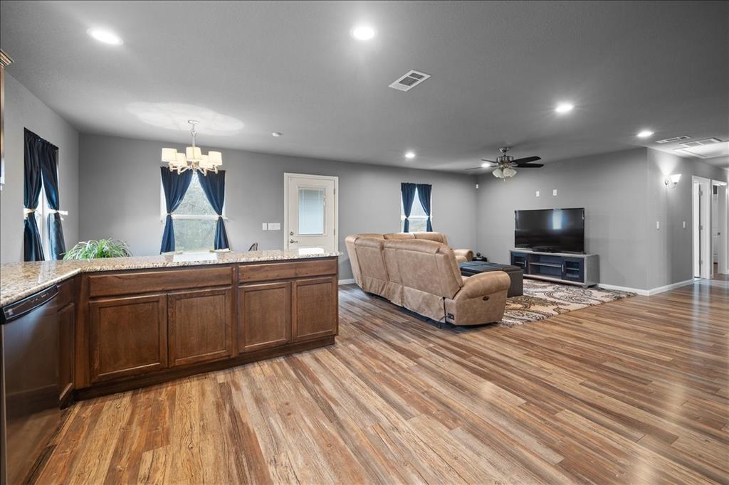 512 Alameda Road Azle, TX 76020 - Photo 10 of 28 a living room with a bed furniture and a flat screen tv