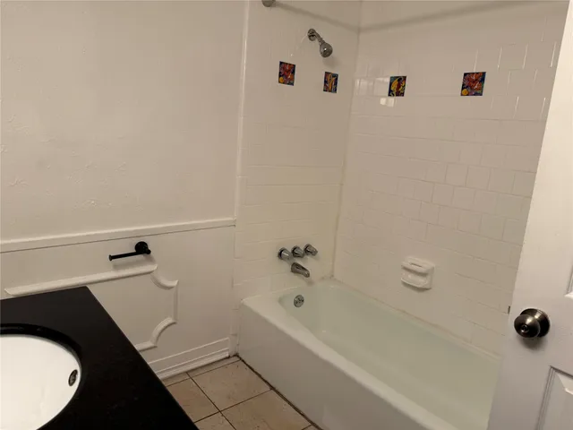 a bathroom with a bathtub and shower