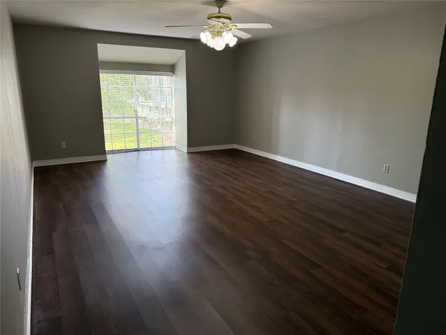 a view of wooden floor and windows in a room