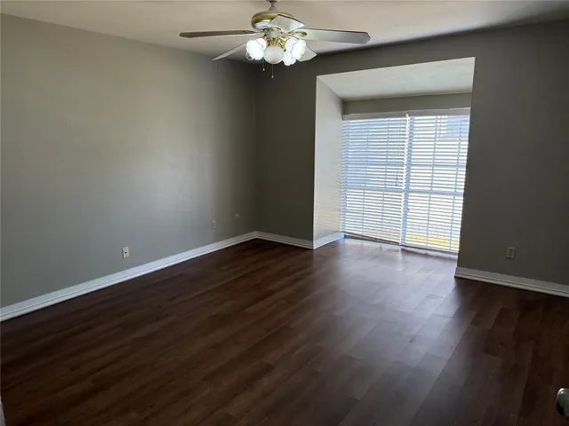 a view of wooden floor and chandelier in living room