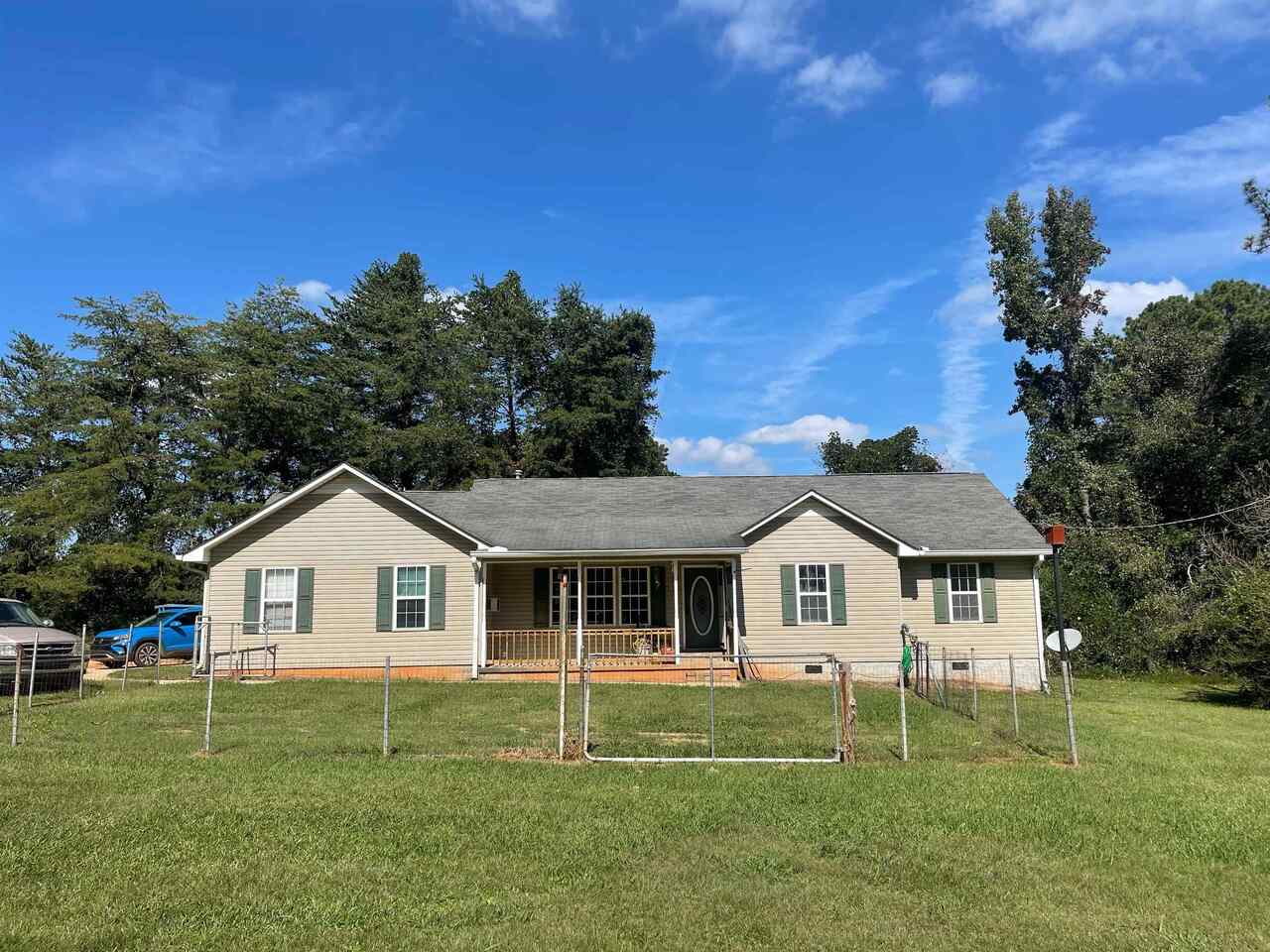 360 North Rover Road Williamson, GA 30292 - Photo 1 of 1 a front view of a house with a yard and trees