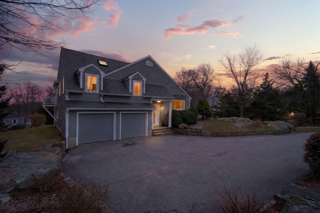 32 Howe Road Cohasset, MA 02025 - Photo 15 of 24 a front view of a house with a yard and garage
