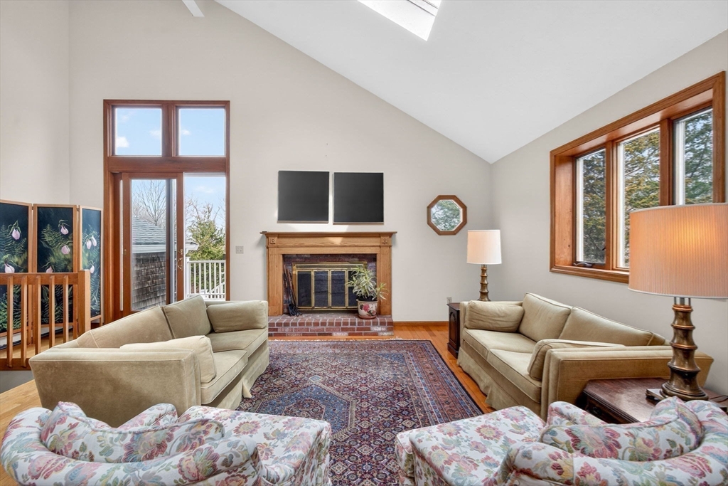 32 Howe Road Cohasset, MA 02025 - Photo 21 of 24 a living room with furniture a fireplace and a large window