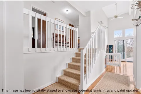 a living room with furniture a fireplace and a large window