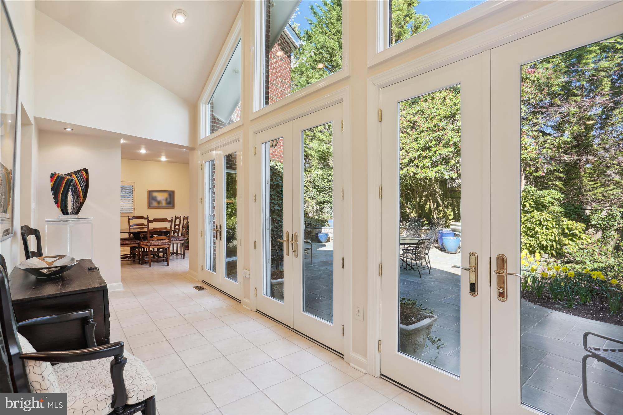 7511 Exeter Road Bethesda, MD 20814 - Photo 10 of 43 Sunroom, to the patio & lush back yard with a pond