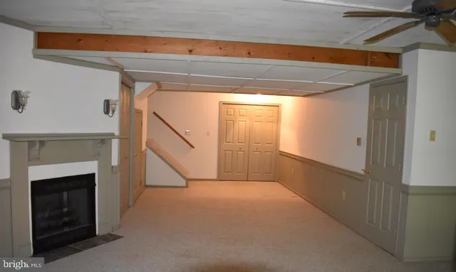 a view of an empty room with a fireplace