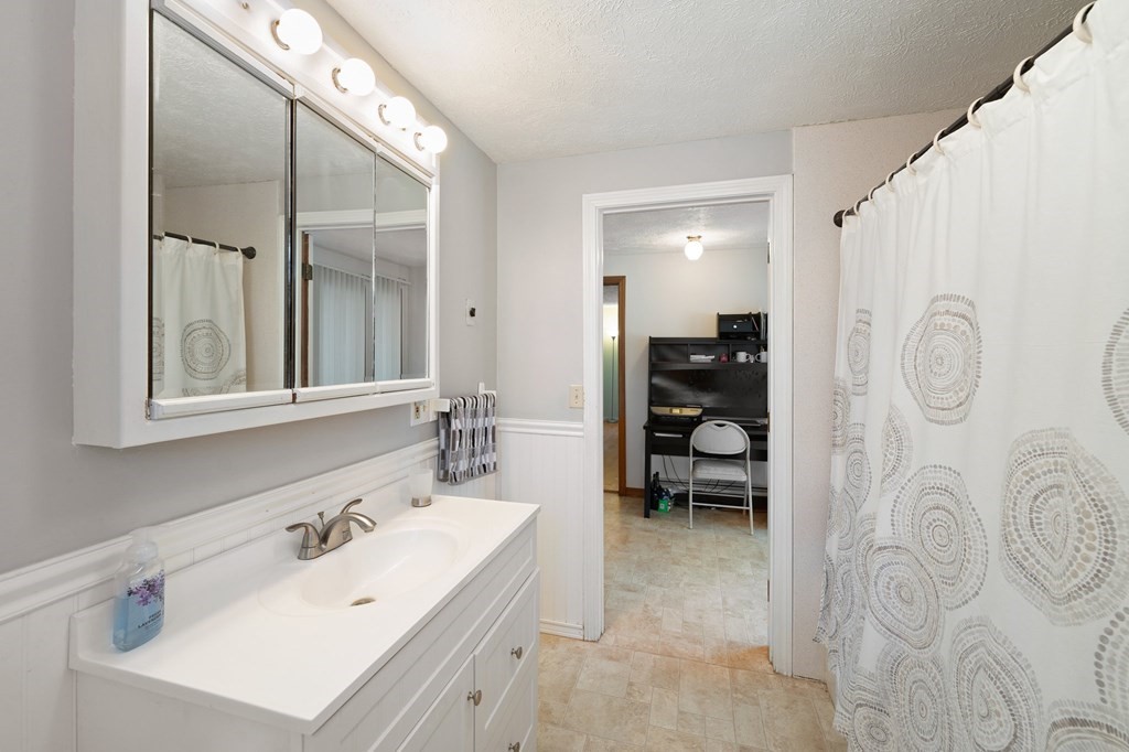 7 Lake Ridge Drive Holland, MA 01521 - Photo 18 of 42 a bathroom with a bathtub sink and mirror