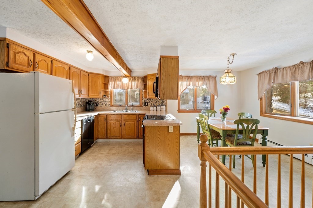 7 Lake Ridge Drive Holland, MA 01521 - Photo 2 of 42 a kitchen with refrigerator a stove and a dining table