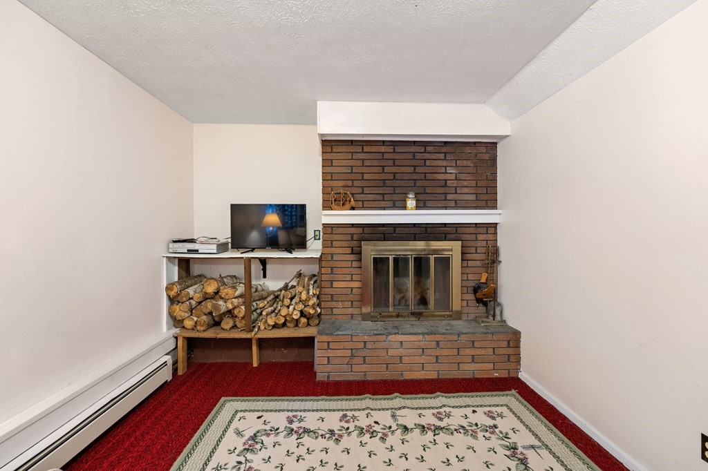 7 Lake Ridge Drive Holland, MA 01521 - Photo 25 of 42 a living room with furniture fireplace and flat screen tv
