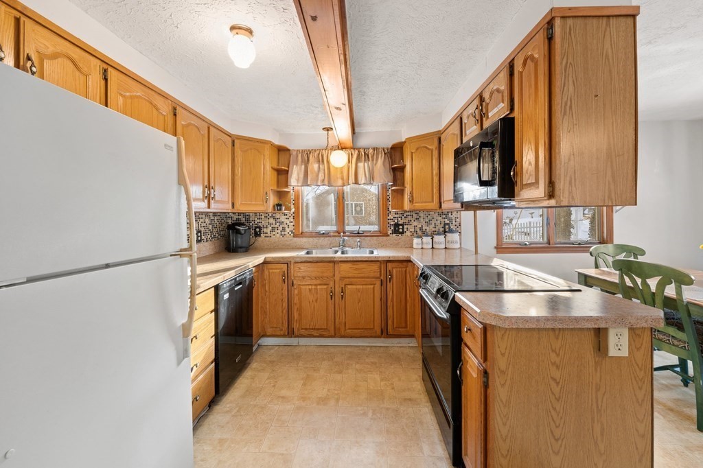 7 Lake Ridge Drive Holland, MA 01521 - Photo 4 of 42 a kitchen with granite countertop a sink a counter top space stainless steel appliances and cabinets