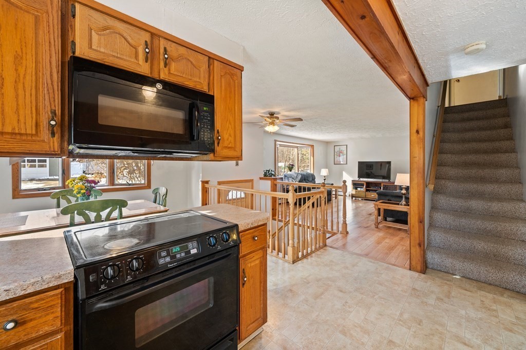 7 Lake Ridge Drive Holland, MA 01521 - Photo 5 of 42 a kitchen with stainless steel appliances a stove a sink and a microwave