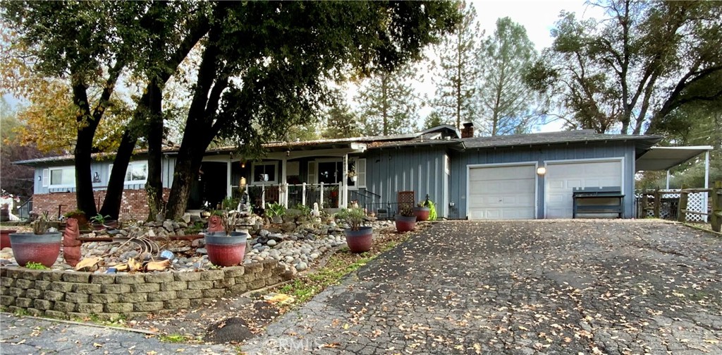 48833 Rock Point Road Oakhurst, CA 93644 - Photo 1 of 1 a front view of a house with yard outdoor seating and barbeque oven