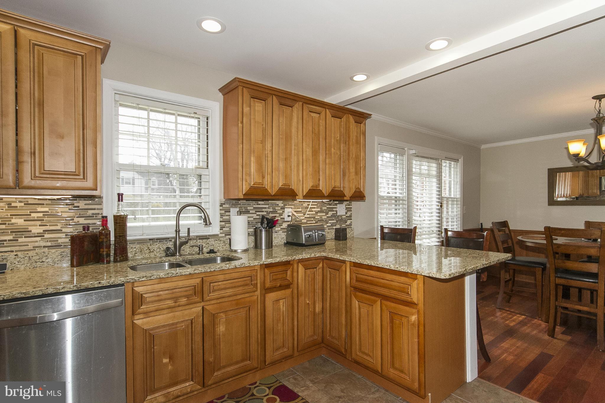 3605 Stoneybrook Road Randallstown, MD 21133 - Photo 11 of 25 a kitchen with stainless steel appliances granite countertop a sink stove and cabinets