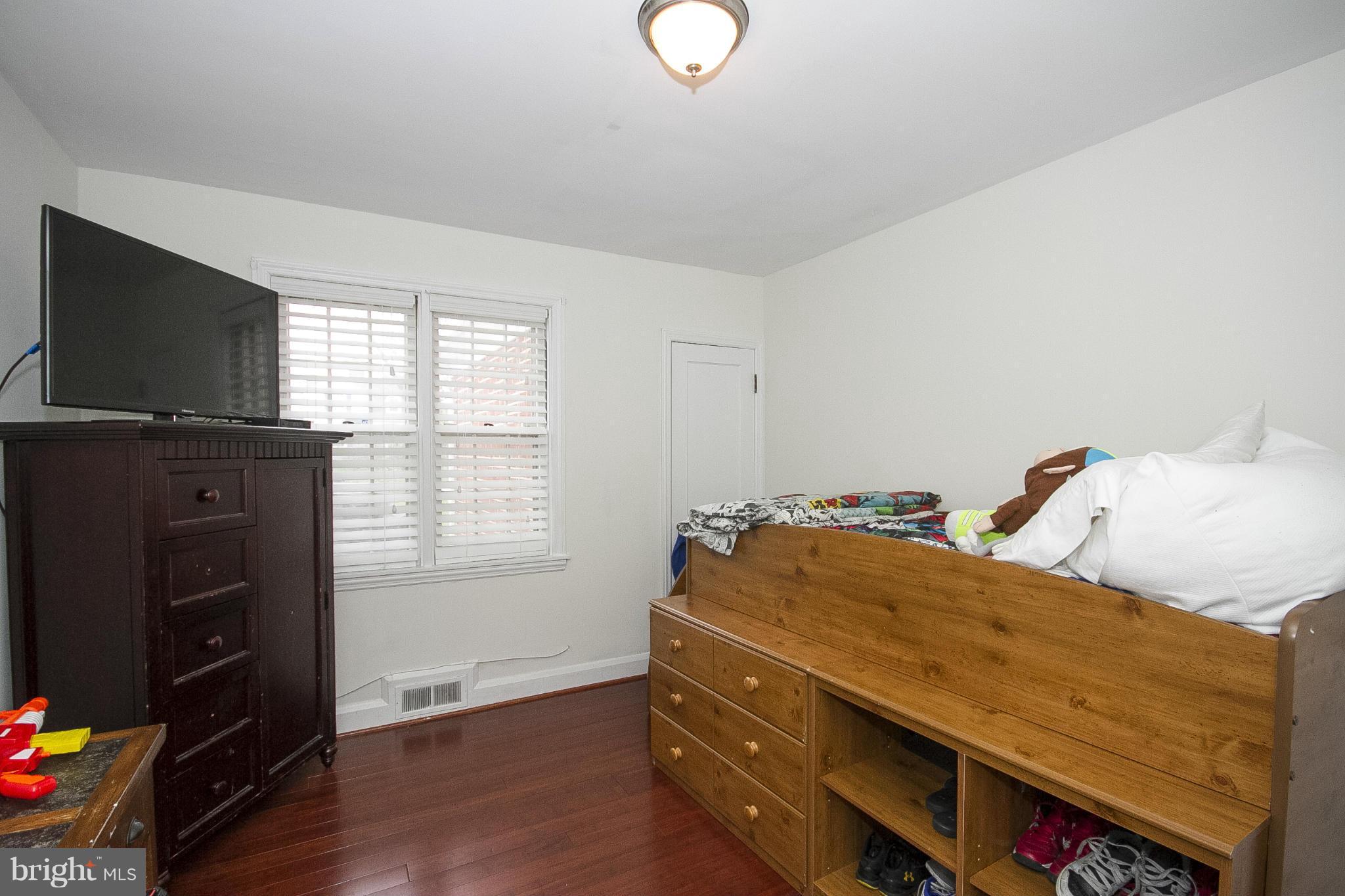 3605 Stoneybrook Road Randallstown, MD 21133 - Photo 17 of 25 a bedroom with a bed and flat screen tv
