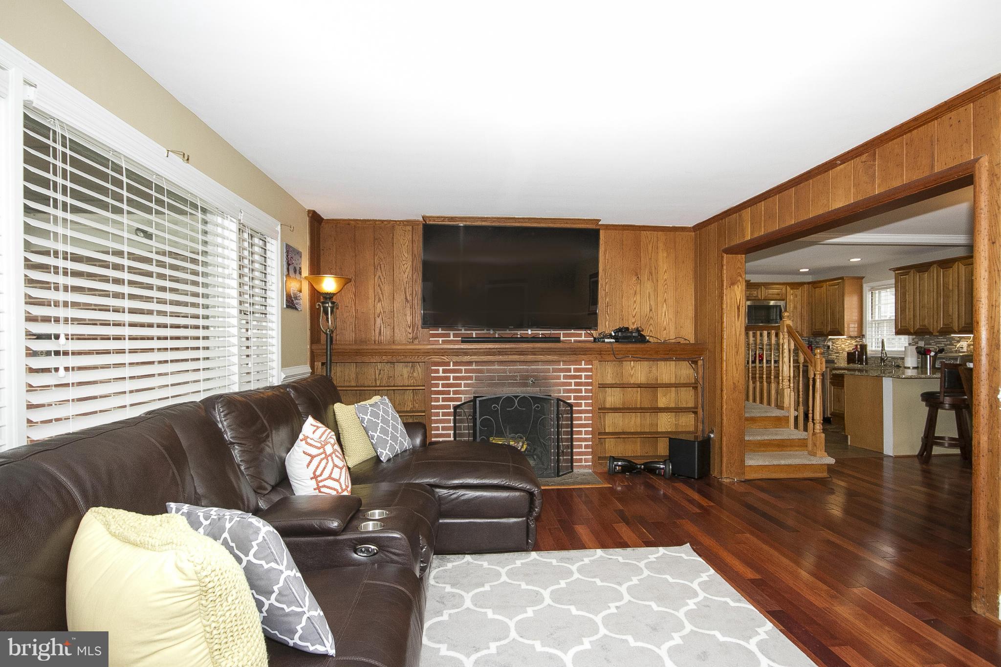 3605 Stoneybrook Road Randallstown, MD 21133 - Photo 3 of 25 a living room with fireplace furniture and a flat screen tv