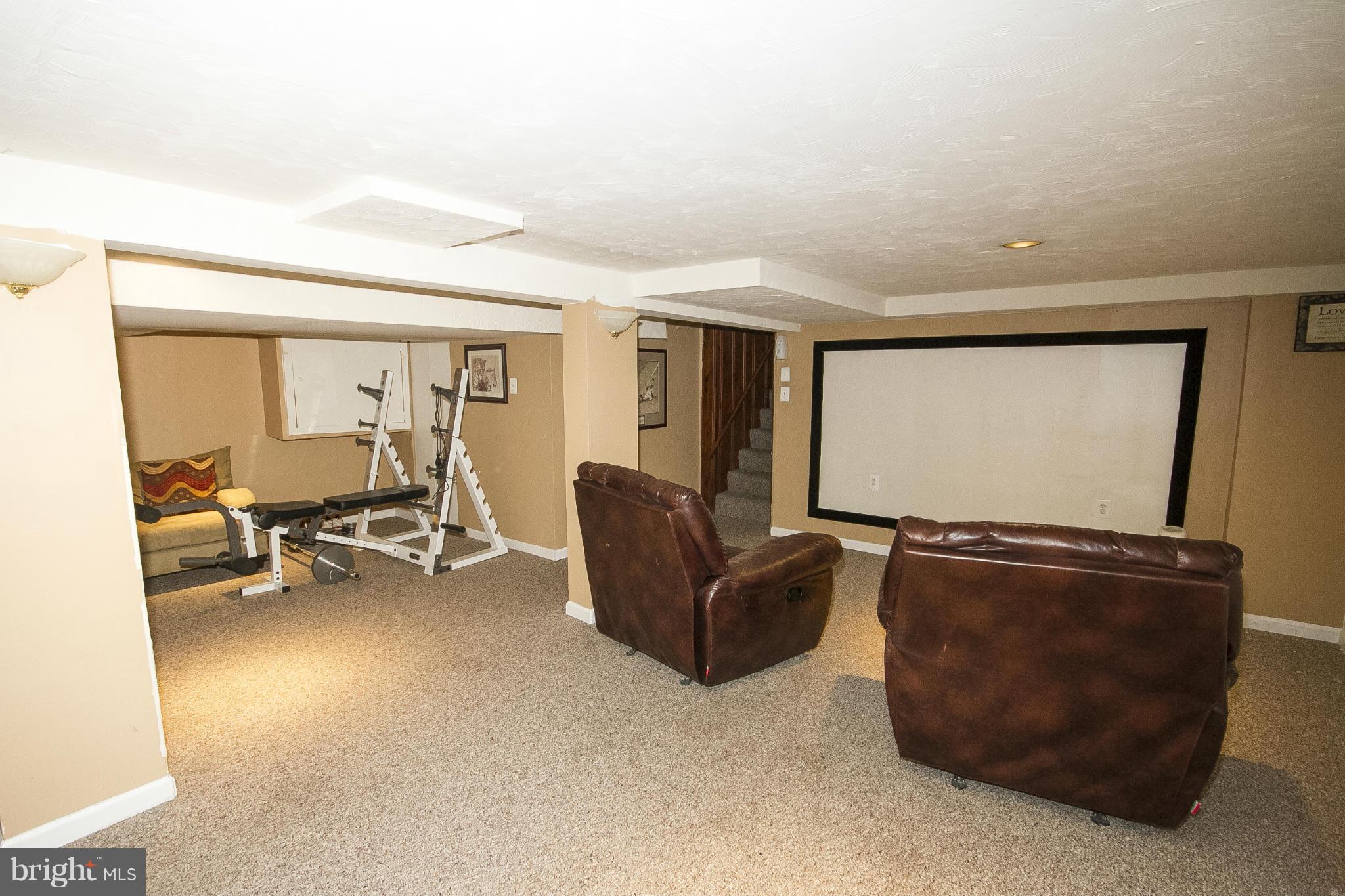 3605 Stoneybrook Road Randallstown, MD 21133 - Photo 22 of 25 a living room with furniture and a flat screen tv