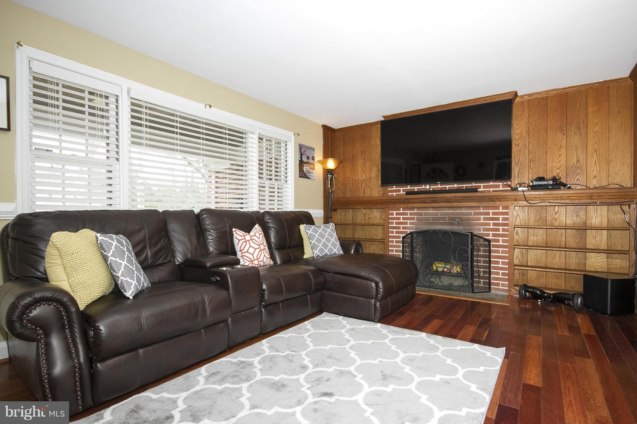 3605 Stoneybrook Road Randallstown, MD 21133 - Photo 4 of 25 a living room with furniture fireplace and flat screen tv