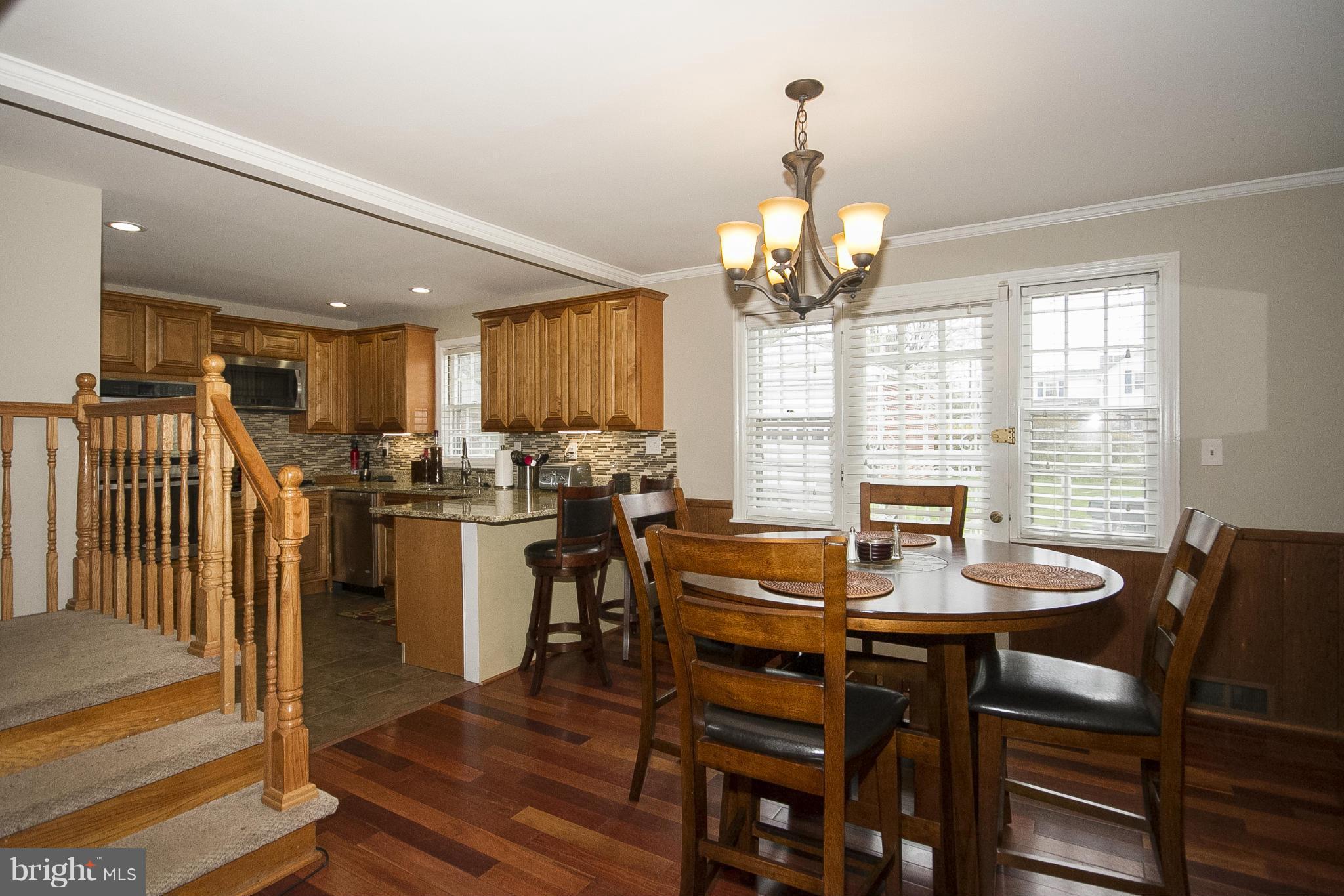 3605 Stoneybrook Road Randallstown, MD 21133 - Photo 6 of 25 a view of a dining room with furniture window and wooden floor