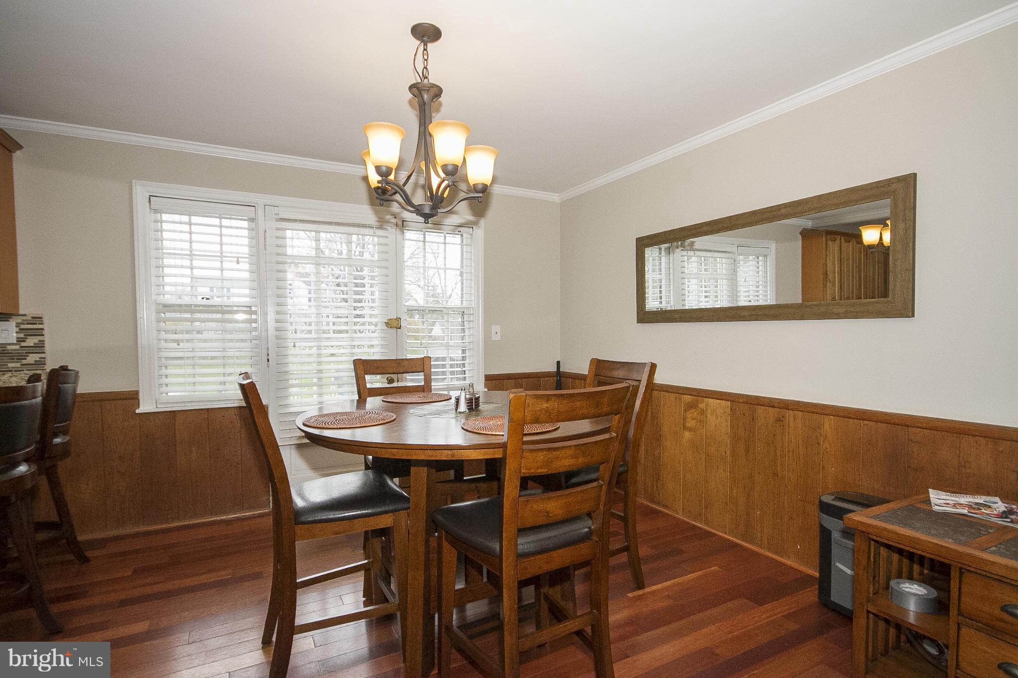 3605 Stoneybrook Road Randallstown, MD 21133 - Photo 8 of 25 a view of a dining room with furniture window and wooden floor