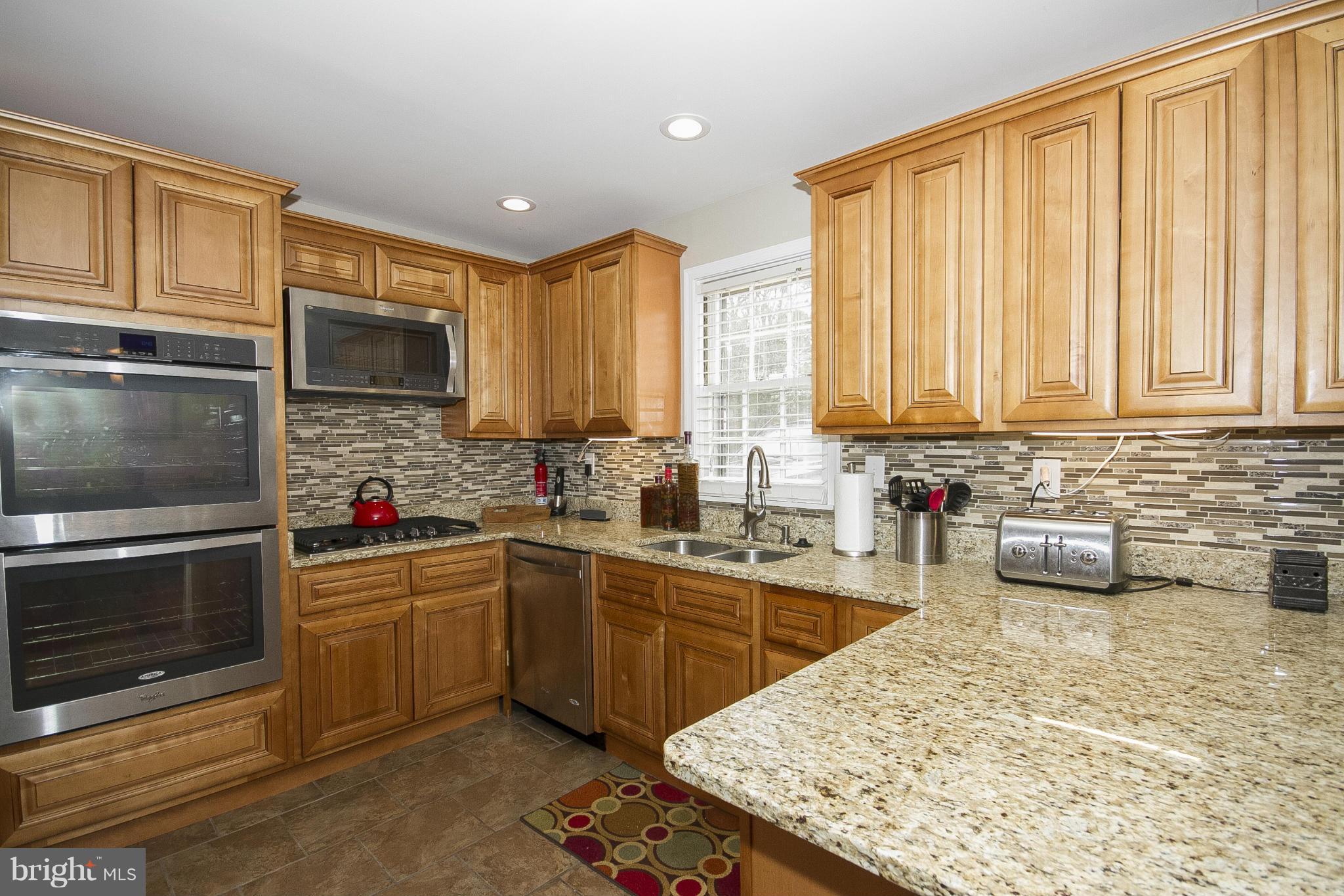 3605 Stoneybrook Road Randallstown, MD 21133 - Photo 10 of 25 a kitchen with a sink stove top oven and microwave