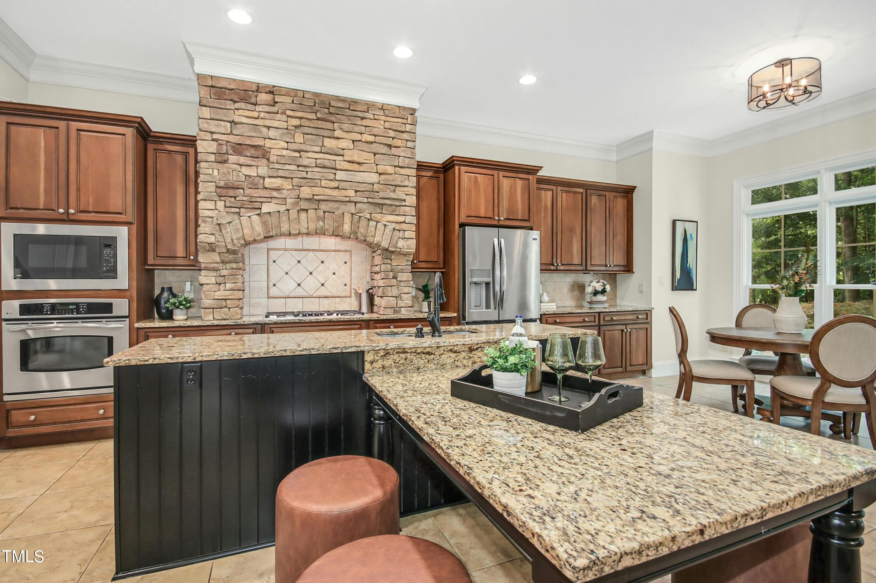 5513 Hickory Leaf Drive Raleigh, NC 27606 - Photo 11 of 41 a kitchen with stainless steel appliances granite countertop a stove a sink and a microwave