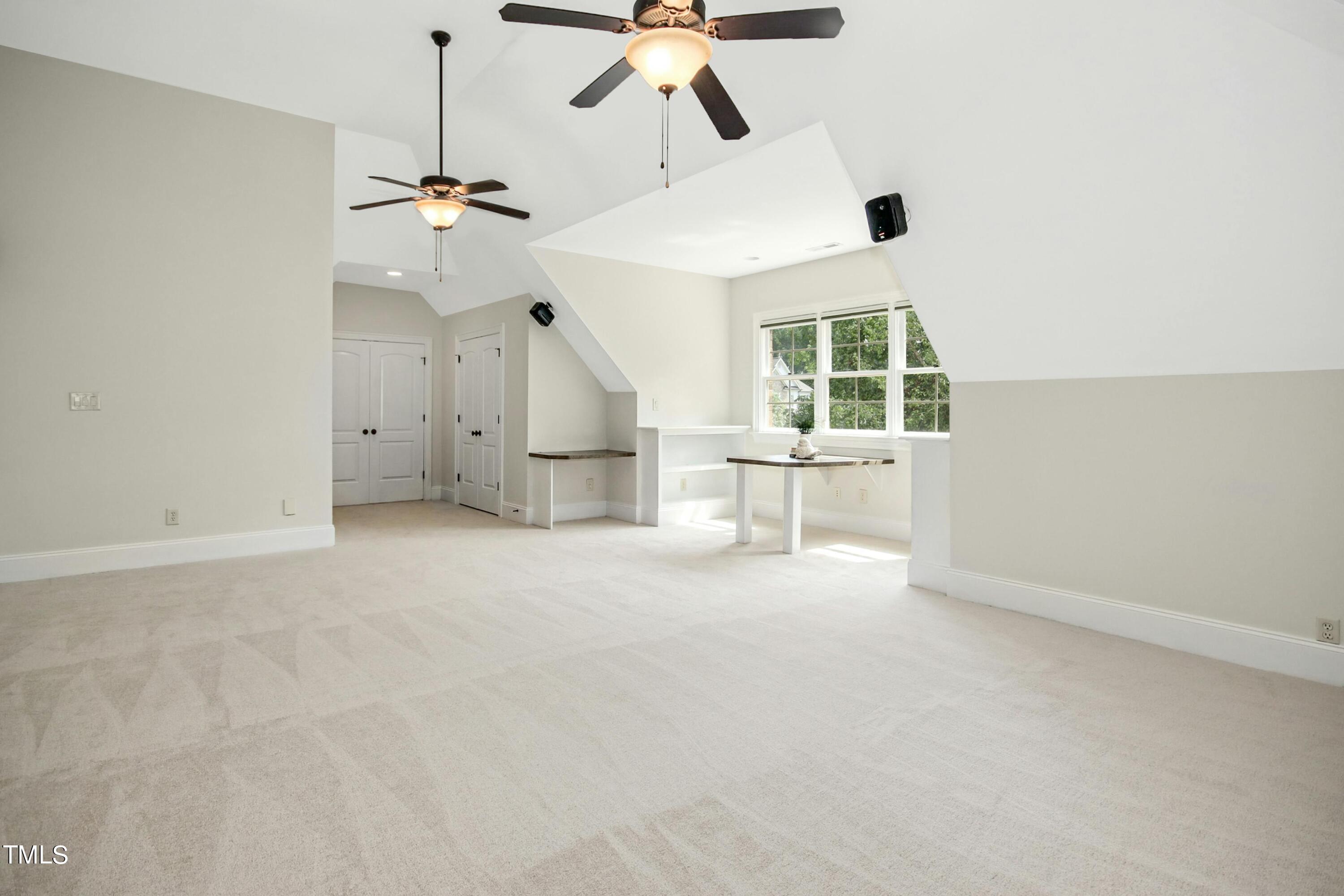 5513 Hickory Leaf Drive Raleigh, NC 27606 - Photo 22 of 41 en empty room with windows and ceiling fan
