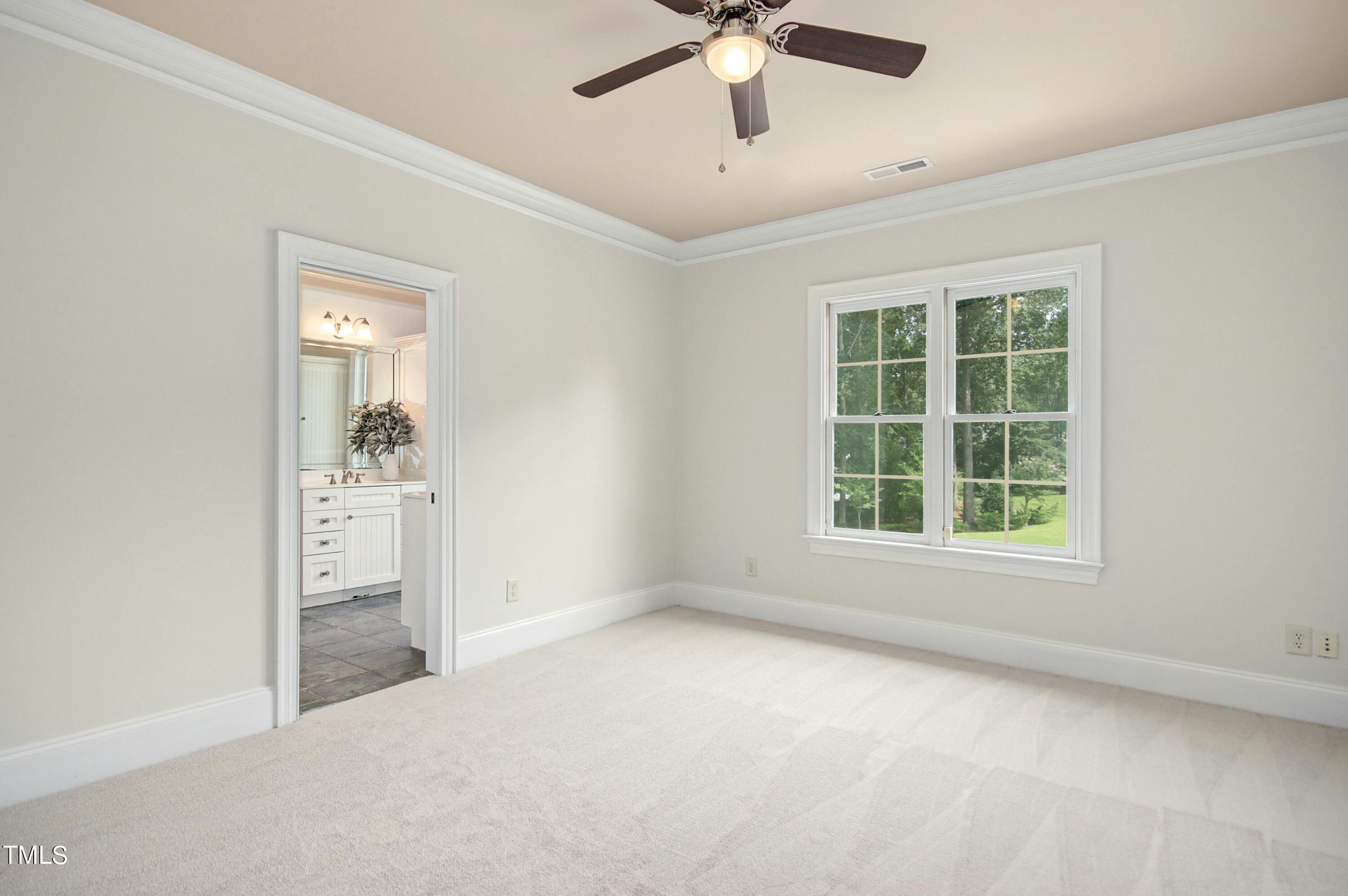 5513 Hickory Leaf Drive Raleigh, NC 27606 - Photo 24 of 41 an empty room with a window and a ceiling fan